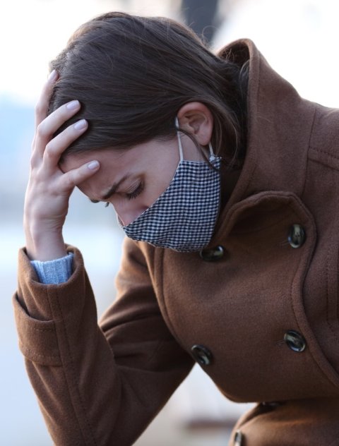 woman holding her head from headache pain
