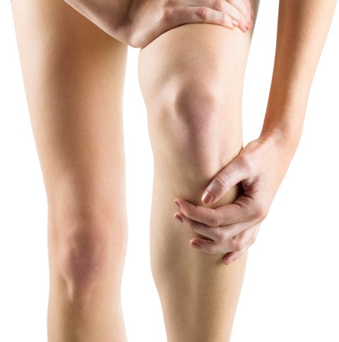 woman rubbing her painful leg