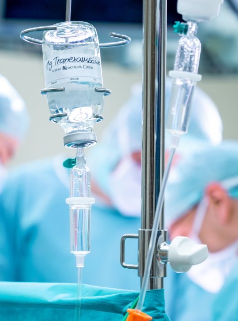 IV drip in operating theatre, blurred background
