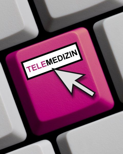 computer keyboard with magenta-colored key labelled telemedizin