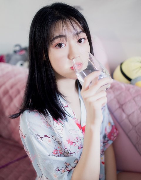 asian woman drinking water from a glass