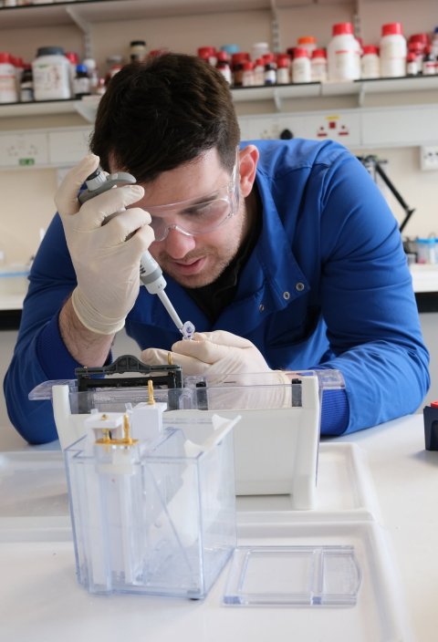 rory hills using a pipette in a medical research laboratory