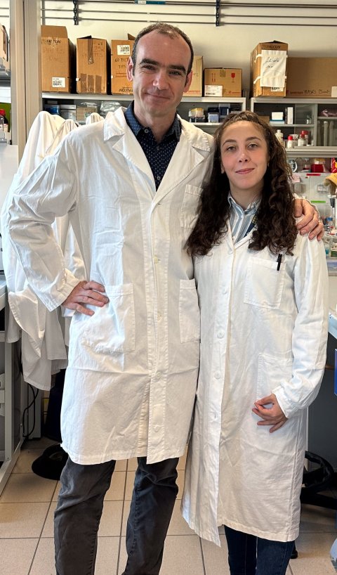 Luca Fava and Vincenza Vigorito standing next to each other in a laboratory setting, wearing white lab coats