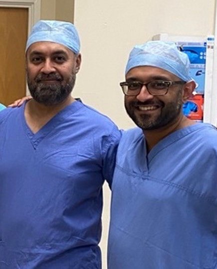 Two surgeons in blue surgical scrubs