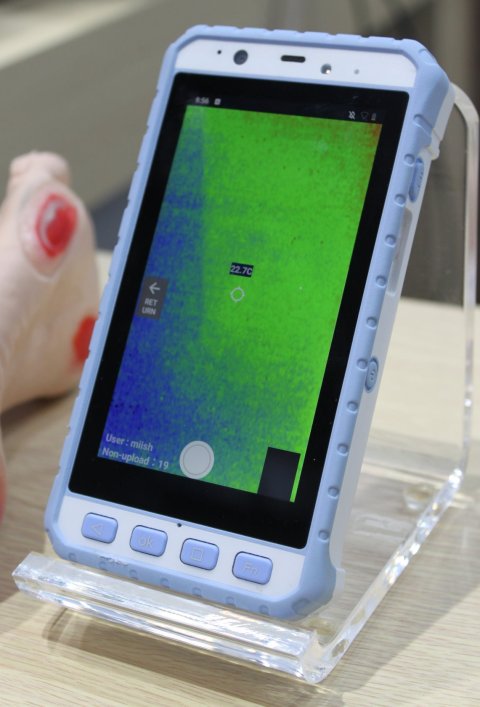A smartphone-like device displaying a blue and green thermal image
