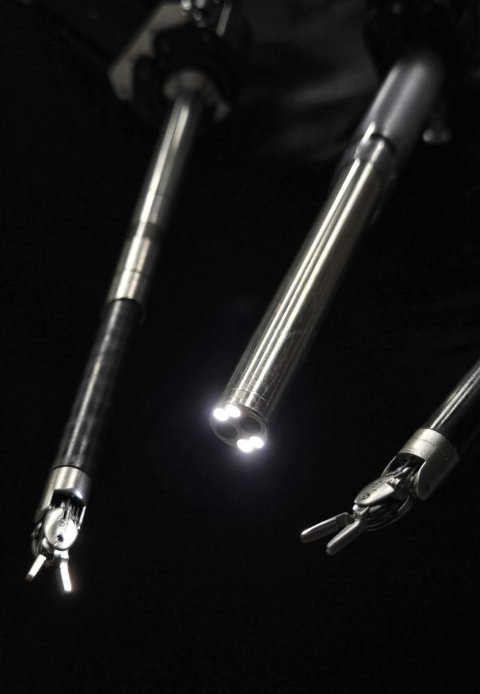 Manipulators of a surgical robot system against a black background