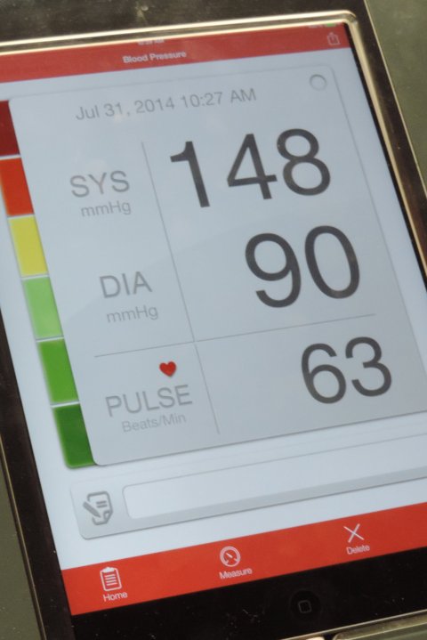 Closeup photo on a smartphone display showing blood pressure measurements