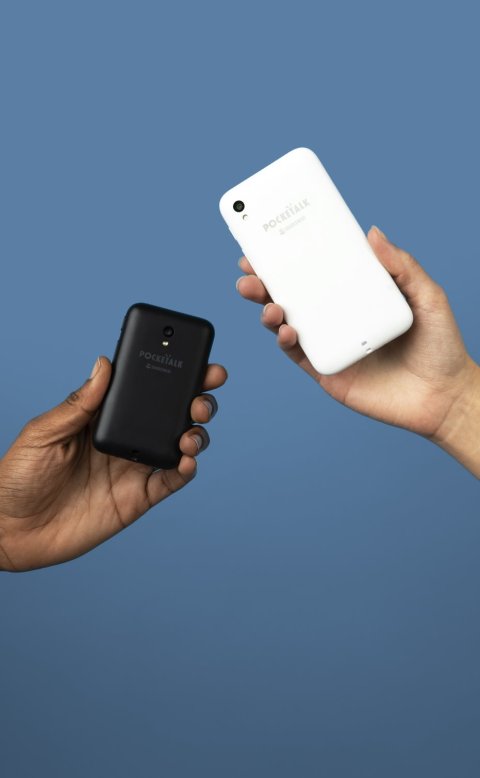 Two hands hold smartphone-like devices from the left and right image sides. The background is blue