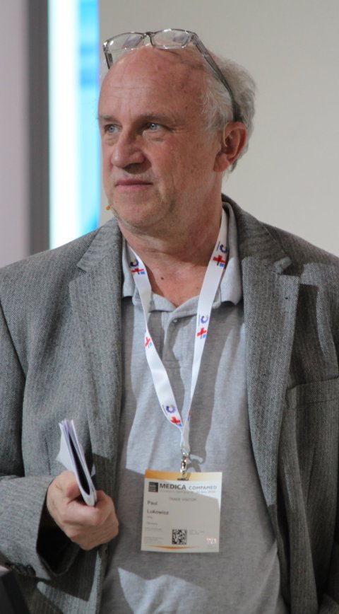 Prof. Dr. Paul Lukowicz steht neben einem Rednerpult