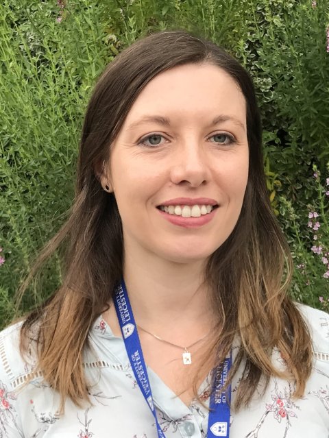 Portrait photo of Professor Louise Wain, in front of a patch of wild green herbs