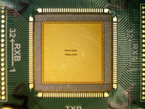 Closeup photo of circuitry around an orange square structure