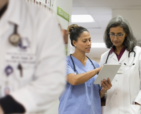 nurse and physician in conversation