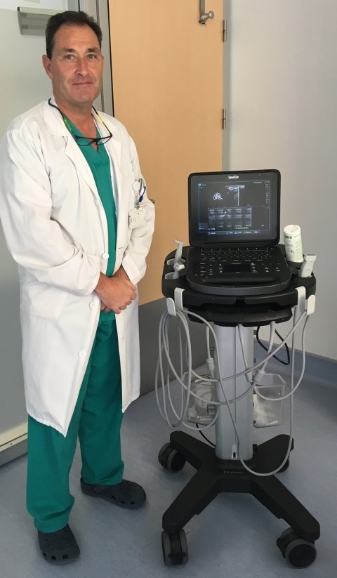 jose luis vazquez martinez standing next to a sonosite ultrasound system